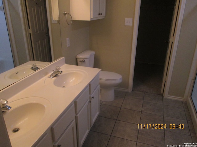 bathroom with tile patterned flooring, vanity, and toilet