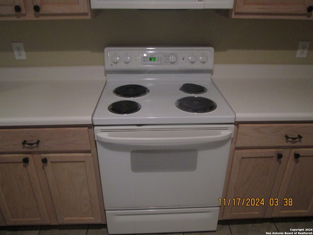 kitchen featuring electric range and tile patterned flooring