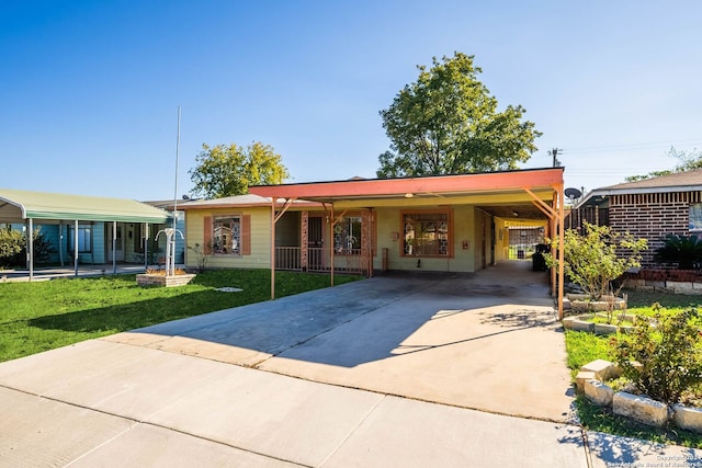 single story home with a front lawn and a carport