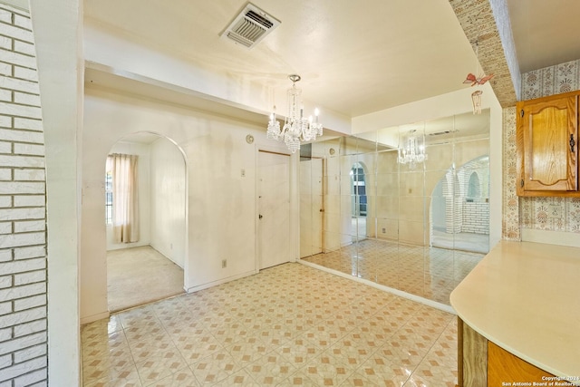 interior space with pendant lighting and a notable chandelier