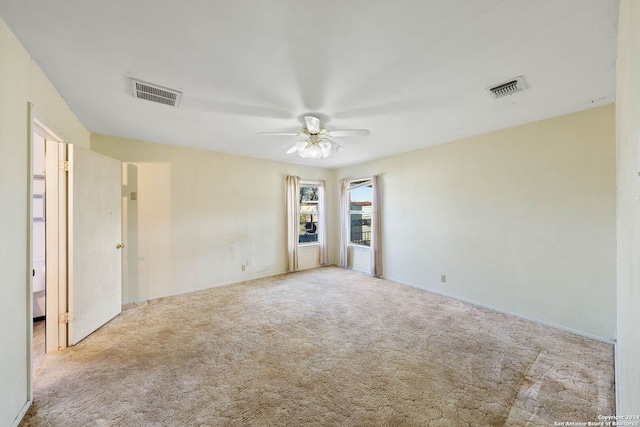 carpeted empty room featuring ceiling fan