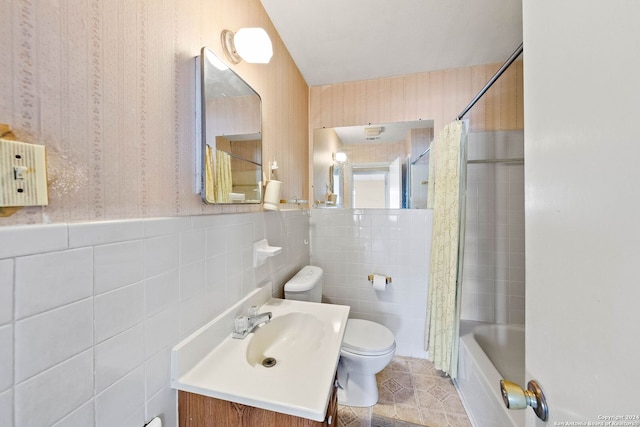 full bathroom with shower / bath combo, vanity, toilet, and tile walls