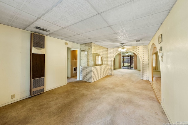 unfurnished living room featuring light carpet and ceiling fan