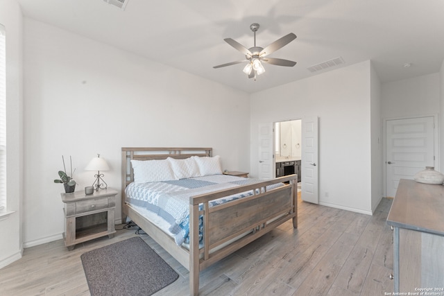 bedroom with ceiling fan, light hardwood / wood-style flooring, and ensuite bathroom