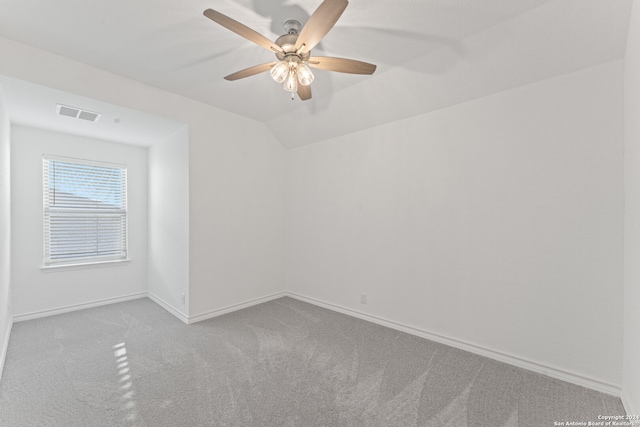 carpeted empty room with ceiling fan and lofted ceiling