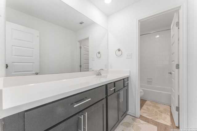 full bathroom featuring shower / bathing tub combination, vanity, toilet, and hardwood / wood-style floors