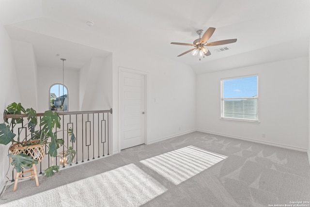 unfurnished room with ceiling fan, light carpet, and vaulted ceiling