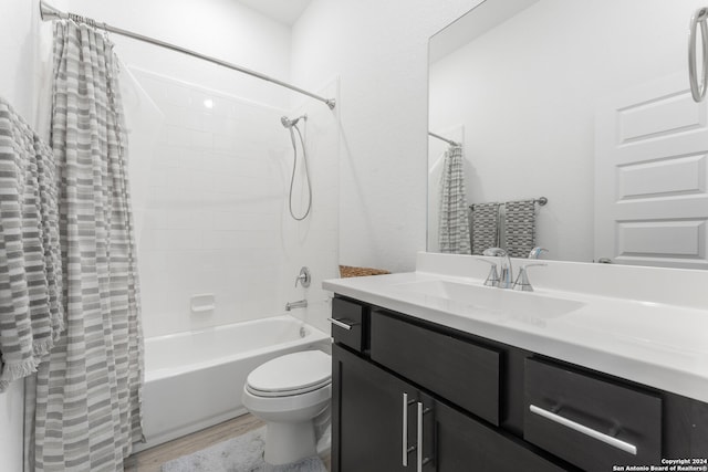 full bathroom featuring wood-type flooring, vanity, toilet, and shower / bathtub combination with curtain