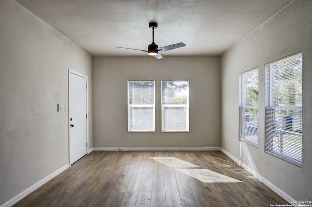 unfurnished room featuring ceiling fan and hardwood / wood-style floors