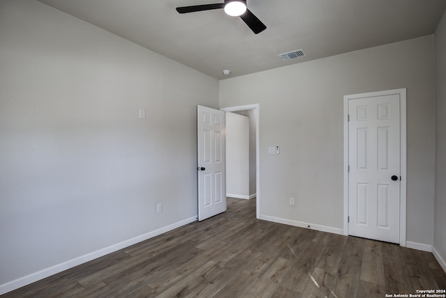 unfurnished bedroom featuring ceiling fan and dark hardwood / wood-style floors