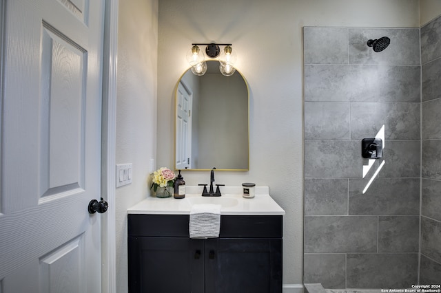 bathroom featuring vanity and tiled shower