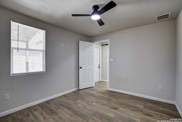 spare room with ceiling fan and wood-type flooring