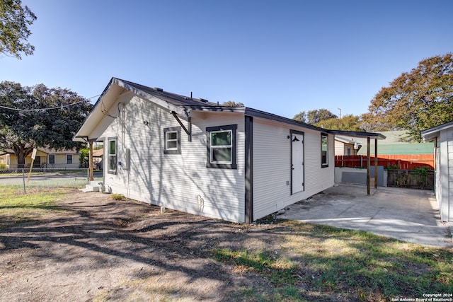 view of side of property featuring a patio