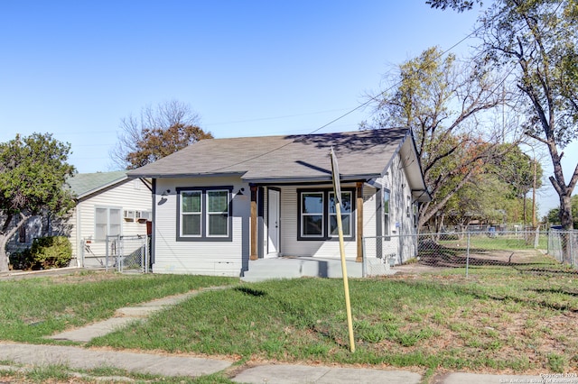 bungalow-style home with a front lawn