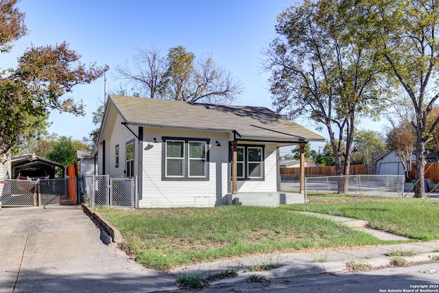 bungalow-style home with a front yard