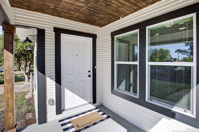 view of exterior entry with a porch