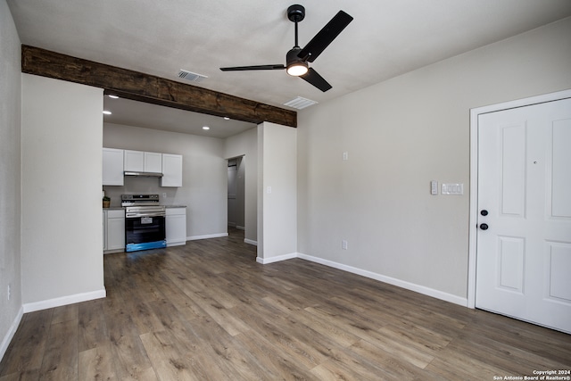 unfurnished living room featuring beam ceiling, ceiling fan, and light hardwood / wood-style floors