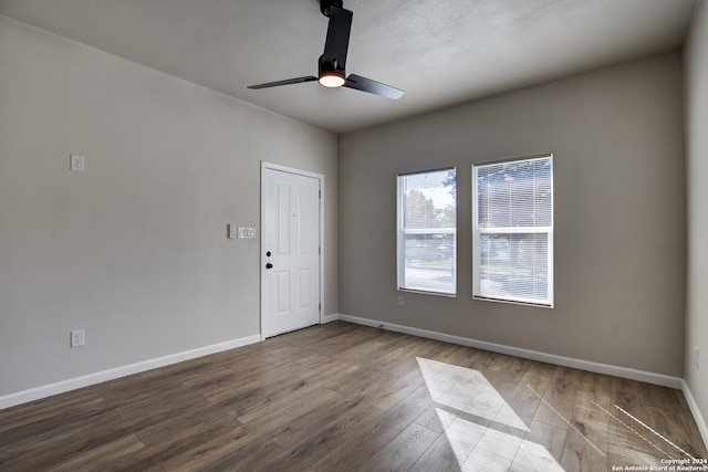 unfurnished room featuring ceiling fan and hardwood / wood-style floors