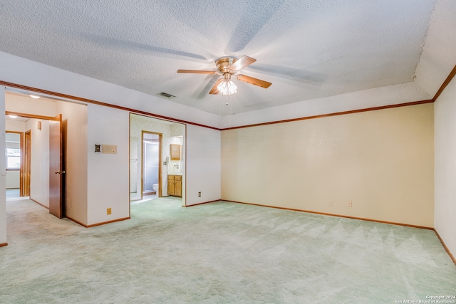 carpeted empty room featuring ceiling fan and a textured ceiling