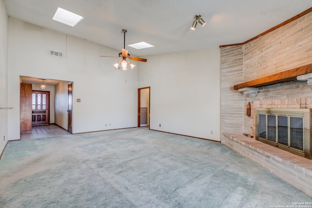 unfurnished living room with ceiling fan, carpet floors, high vaulted ceiling, and a brick fireplace