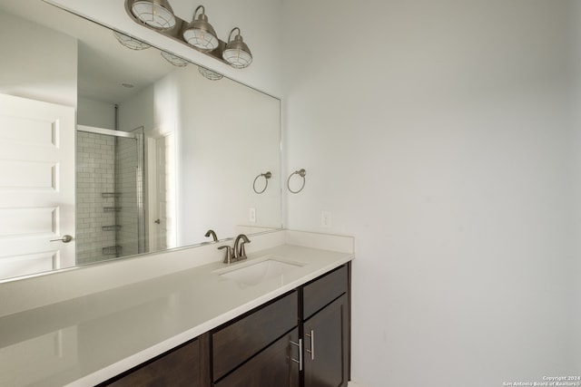 bathroom with a shower with door and vanity