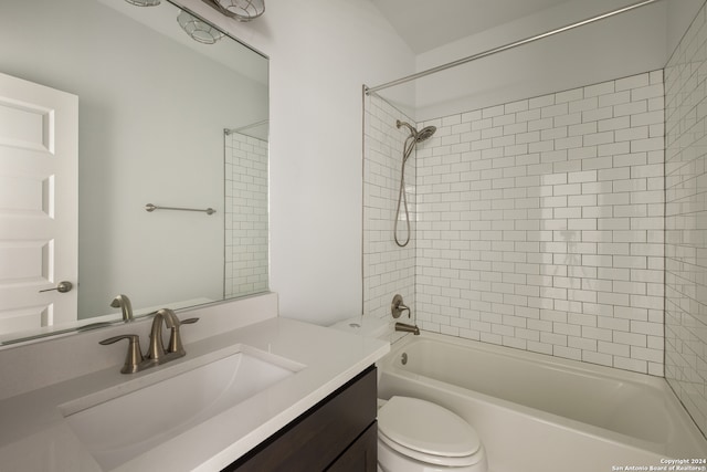 full bathroom with toilet, vanity, and tiled shower / bath