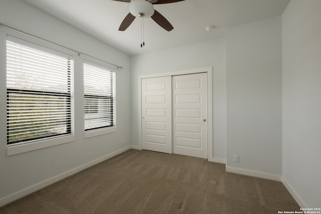 unfurnished bedroom featuring carpet, ceiling fan, and a closet