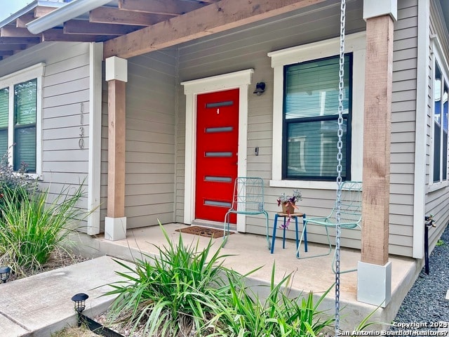 doorway to property featuring covered porch