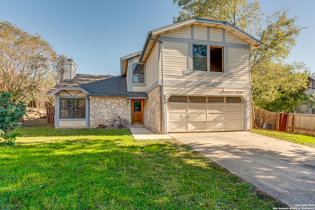 view of front of home with a front yard and a garage