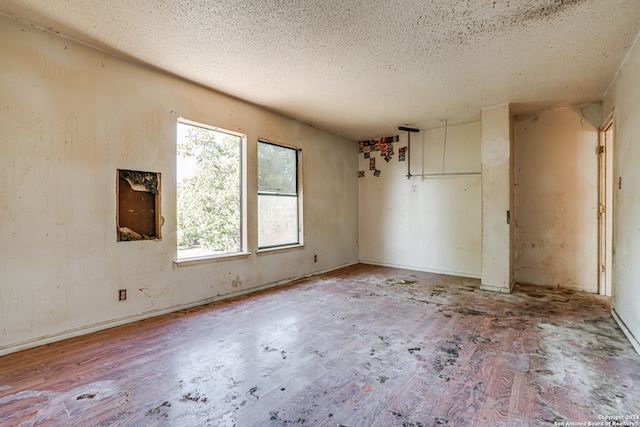 spare room with a textured ceiling