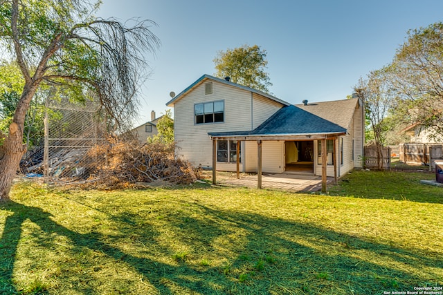 rear view of property with a lawn and a patio area