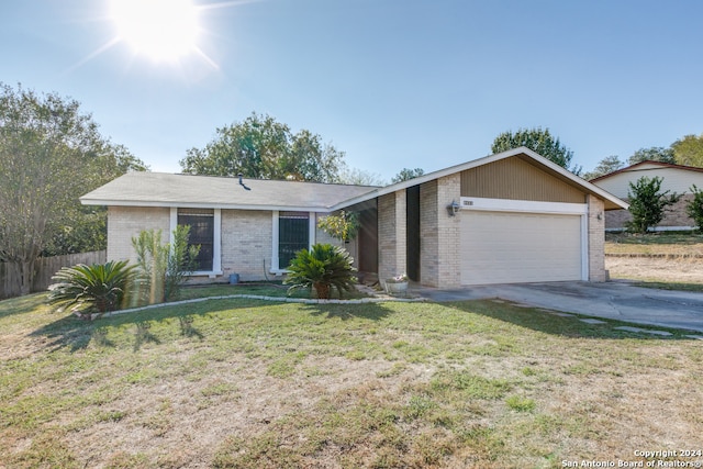 single story home featuring a front yard and a garage