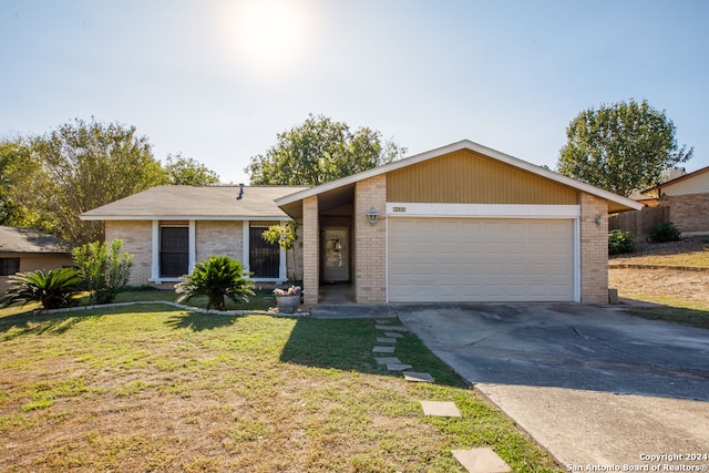 ranch-style house with a front yard and a garage