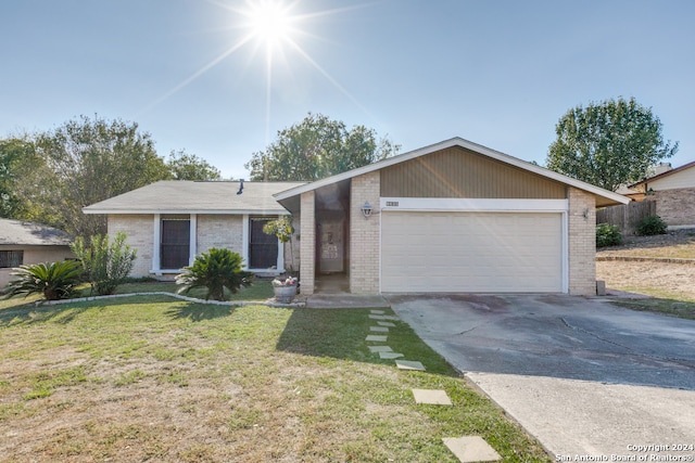 ranch-style home featuring a garage and a front lawn