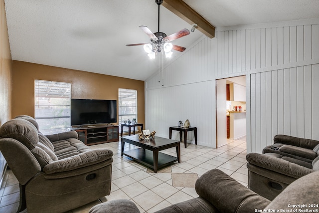 tiled living room featuring a textured ceiling, lofted ceiling with beams, ceiling fan, and wooden walls