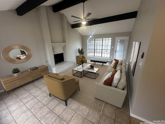 tiled living room with vaulted ceiling with beams, ceiling fan, and a brick fireplace