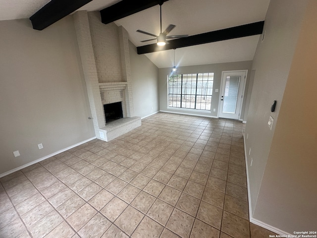 unfurnished living room with ceiling fan, a fireplace, light tile patterned flooring, and lofted ceiling with beams