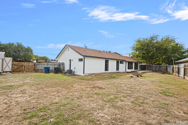 back of house featuring a yard and cooling unit