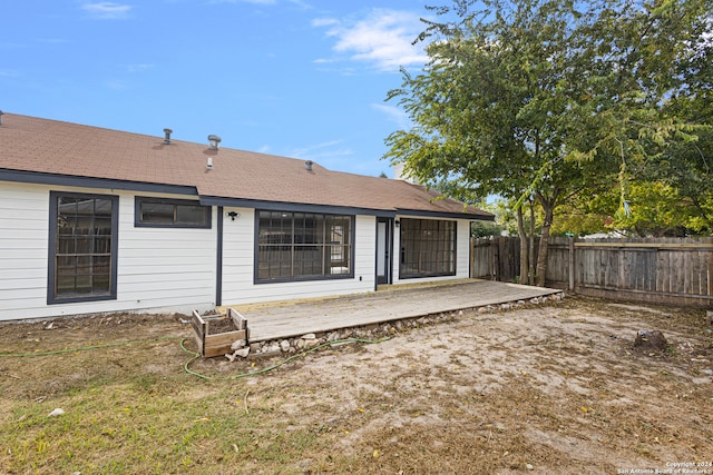 back of property featuring a wooden deck