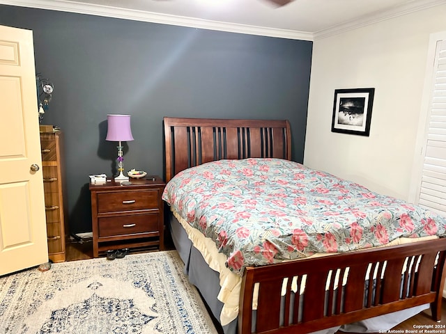 bedroom featuring hardwood / wood-style flooring and crown molding