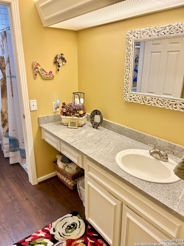 bathroom with vanity and hardwood / wood-style flooring