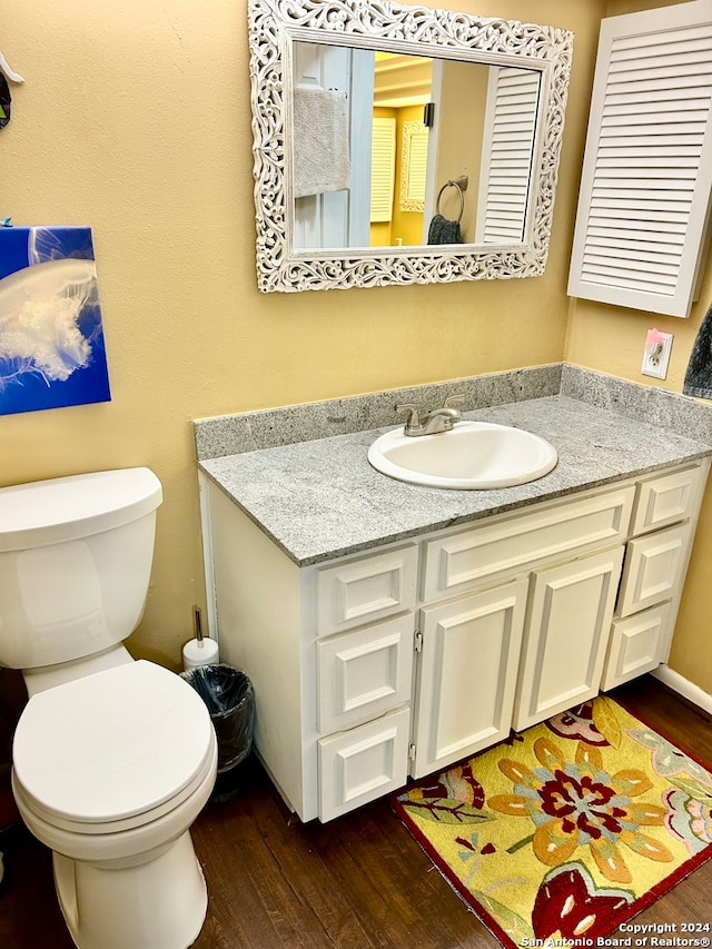 bathroom featuring hardwood / wood-style floors, vanity, and toilet