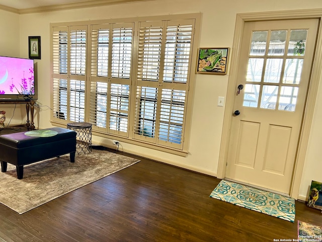 entryway featuring dark wood-type flooring, plenty of natural light, and crown molding