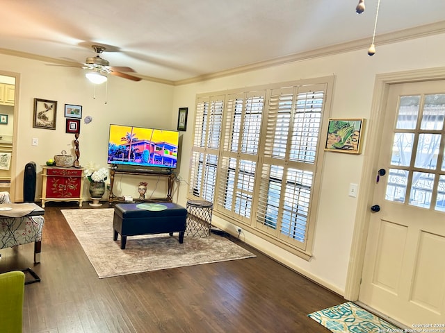 sitting room featuring ceiling fan, a healthy amount of sunlight, dark hardwood / wood-style flooring, and ornamental molding