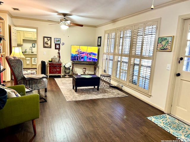 living room with sink, ceiling fan, dark hardwood / wood-style flooring, and crown molding