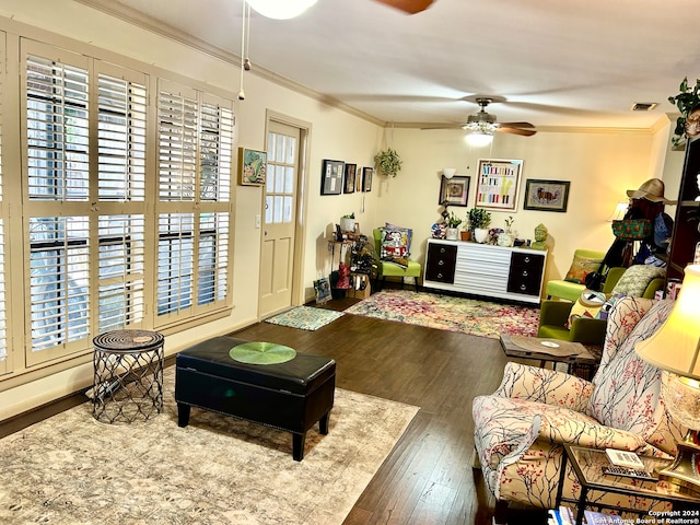 living room with a wealth of natural light, hardwood / wood-style floors, ceiling fan, and ornamental molding