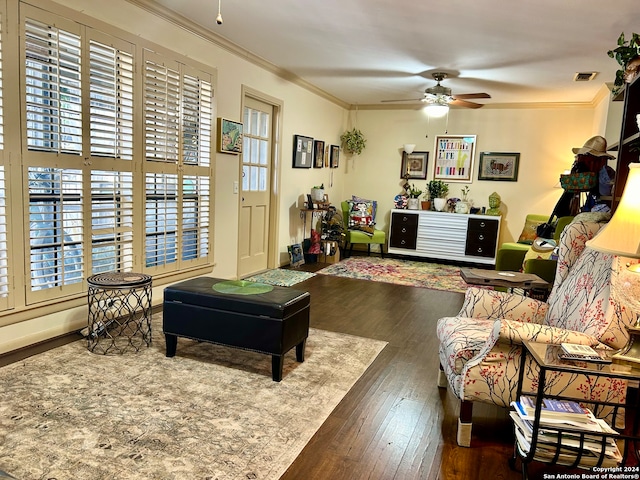 living room with dark hardwood / wood-style floors, a wealth of natural light, and ornamental molding