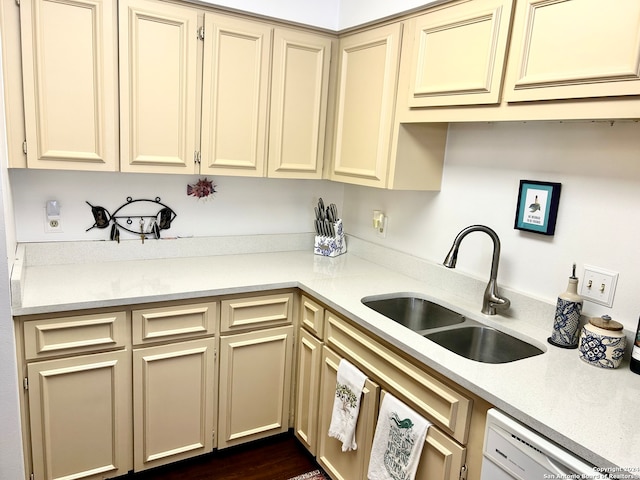 kitchen featuring cream cabinetry, dishwasher, dark hardwood / wood-style floors, and sink