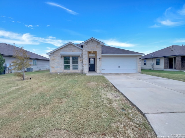 view of front of home with a garage and a front lawn