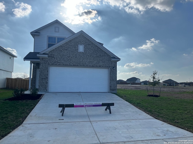 front of property with a garage and a front yard